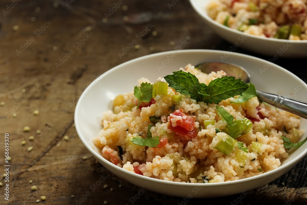 Tabbouleh Salad - Popular vegetarian Mediterranean dish made of fresh cucumber,tomatoes,parsley and coucous Tabbouleh Salad - Popular vegetarian Mediterranean dish made of fresh cucumber,tomatoes,parsley and coucous