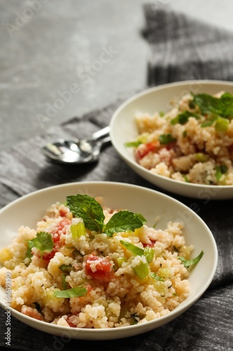 Tabbouleh Salad - Popular vegetarian Mediterranean dish made of fresh cucumber,tomatoes,parsley and coucous