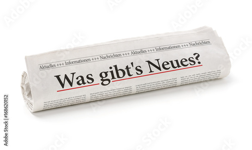 Zeitungsrolle mit der Überschrift Was gibts Neues photo