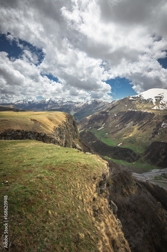 Scenic view on Caucasus mountains in Georgia. A small river flows down the gorge