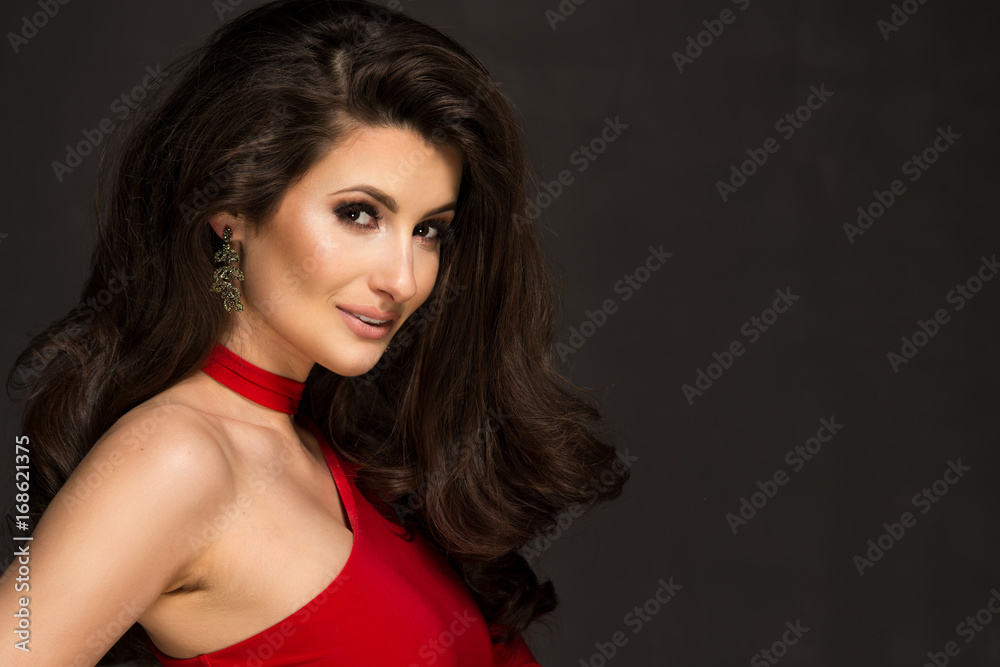 Sensual beautiful blonde woman posing in red dress. Girl with long curly hair. Sensual beautiful blonde woman posing in red dress. Girl with long curly hair.