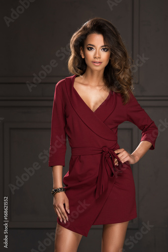 Beauty Afro young woman in red dressin dark room