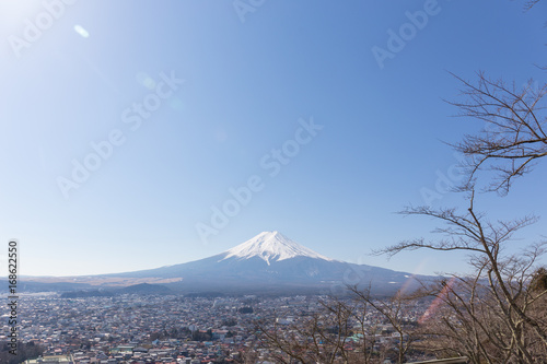 Fuji mountain with blue sky and len flares on up left