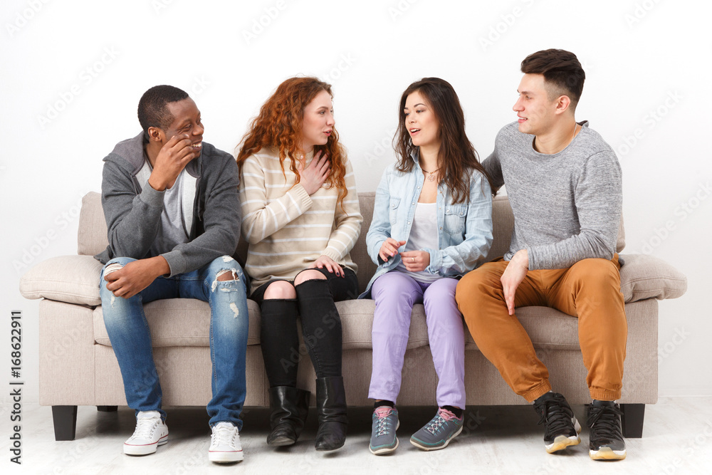 Happy young friends, casual people sitting on couch Happy young friends, casual people sitting on couch