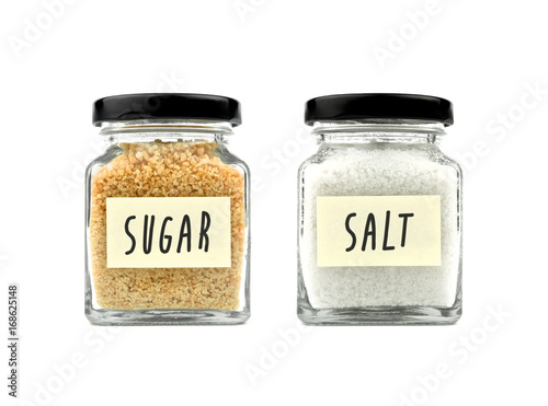 Brown sugar and salt set in a glass bottle isolated on white background, with word on yellow stick note paper and black lid. Modern and stylish. Close up.