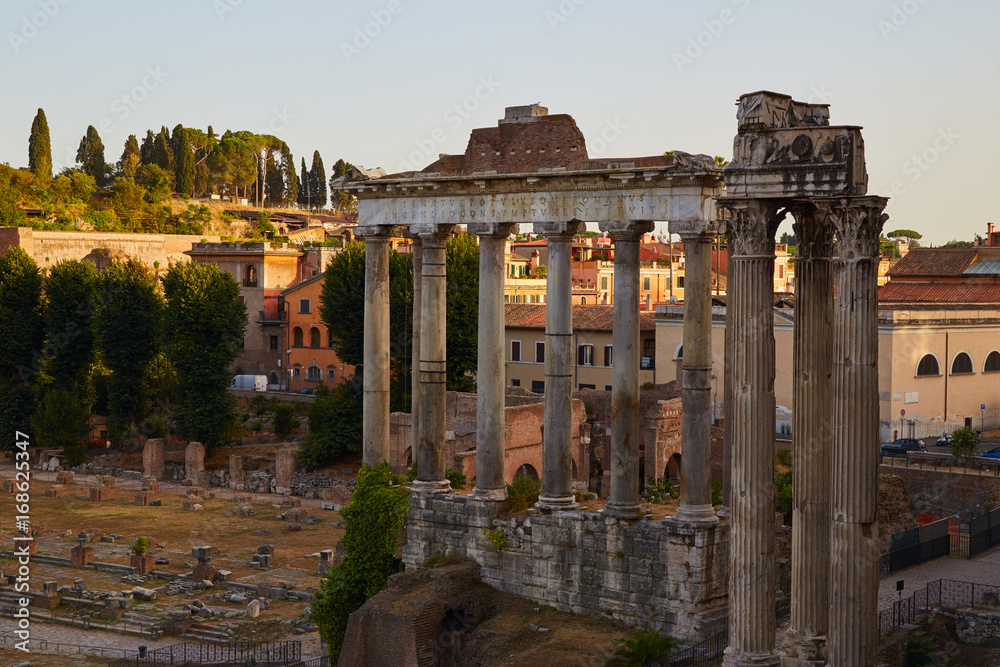 Roman forum. Columns of the temple of Saturn in the evening. Rome, Italy