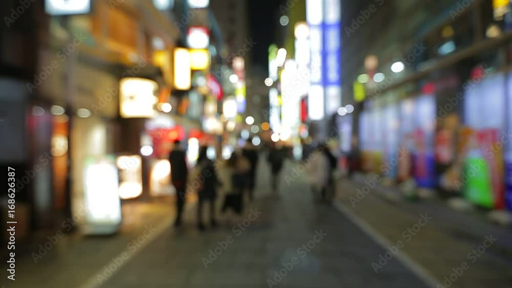 Pedestrians walking in city night with lights Pedestrians walking in city night with lights