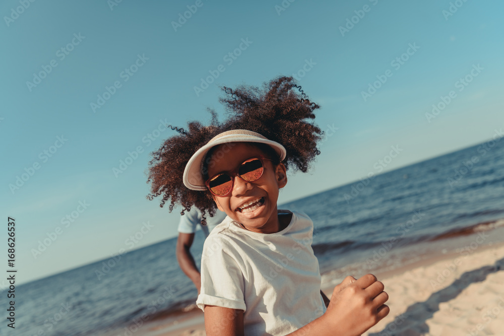 african american child running on beach african american child running on beach