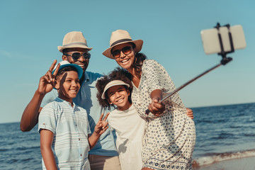 family taking selfie on beach