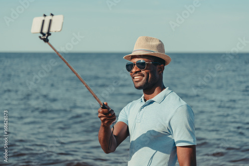 man taking selfie on beach