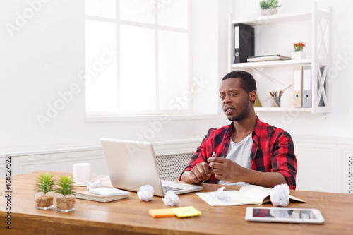 Black businessman in casual office, work with laptop