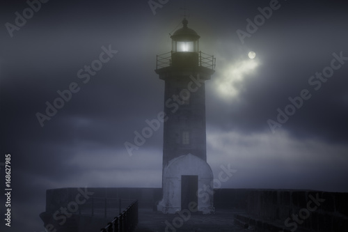 Lighthouse in a foggy night
