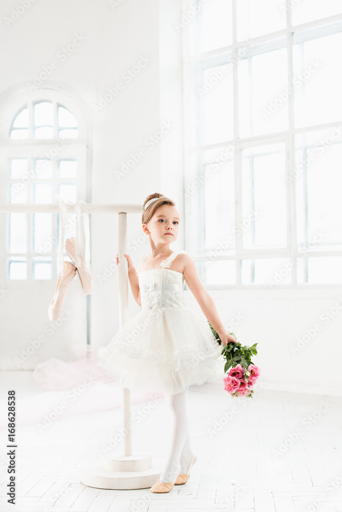 Little ballerina girl in a tutu. Adorable child dancing classical ballet in a white studio. Little ballerina girl in a tutu. Adorable child dancing classical ballet in a white studio.