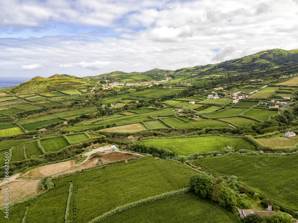 Fototapeta premium Aerial view of fields outside of the village of Ginetes in Sao Miguel Island, Portugal.