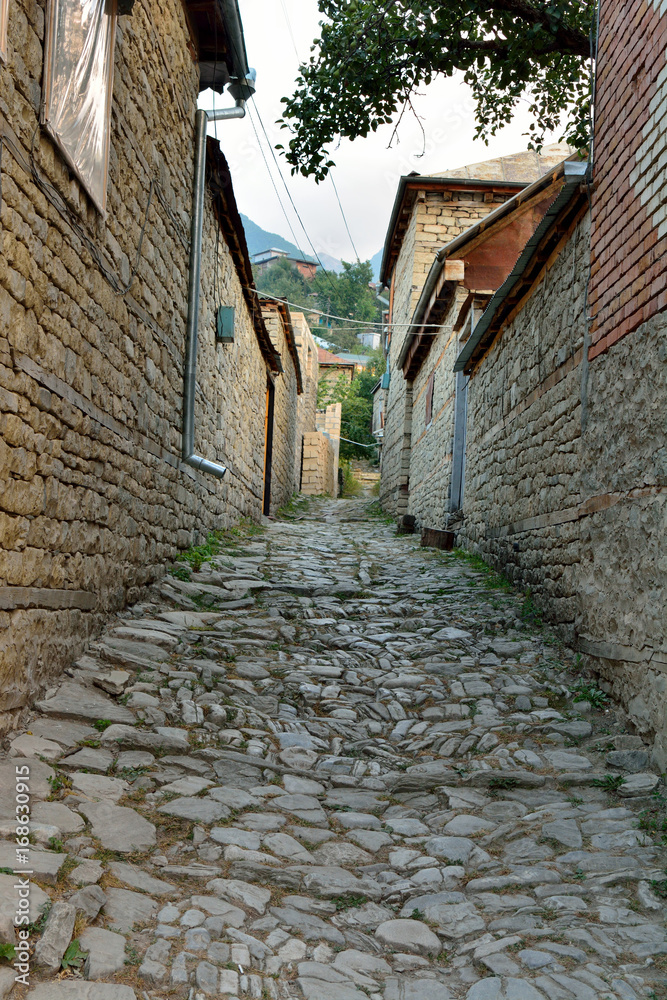 Narrow lane in Lahic village in Azerbaijan, with cobblestone pavement.