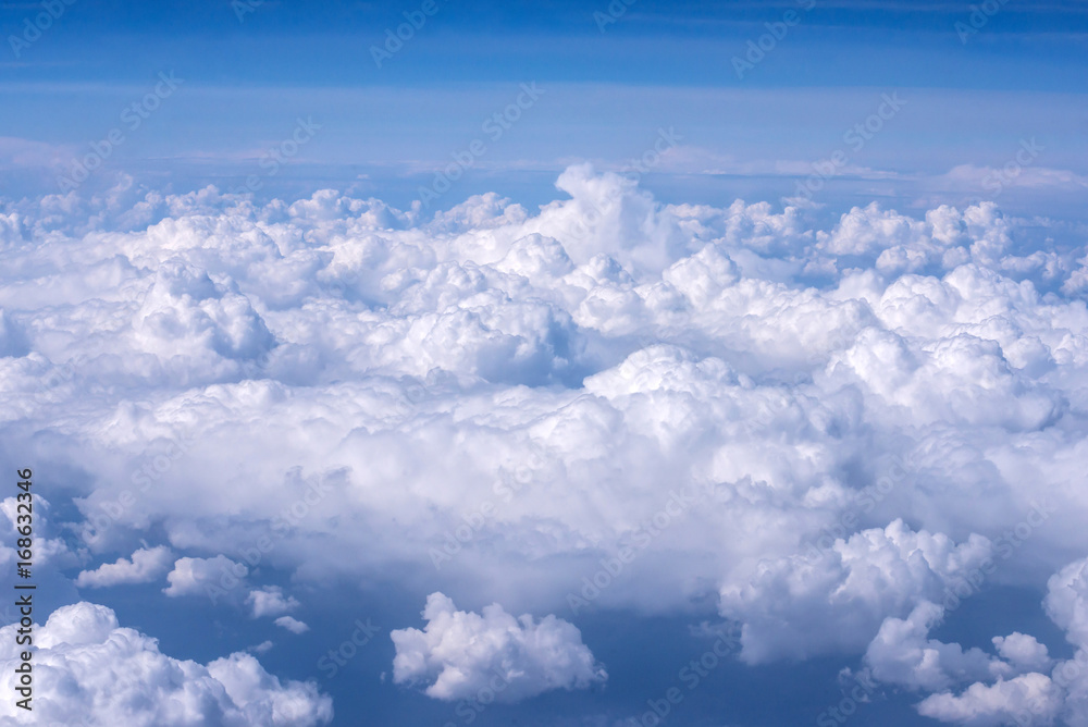 View of blue sky above the clouds from airplane window View of blue sky above the clouds from airplane window