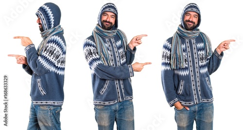 Set of Man with winter clothes pointing to the lateral
