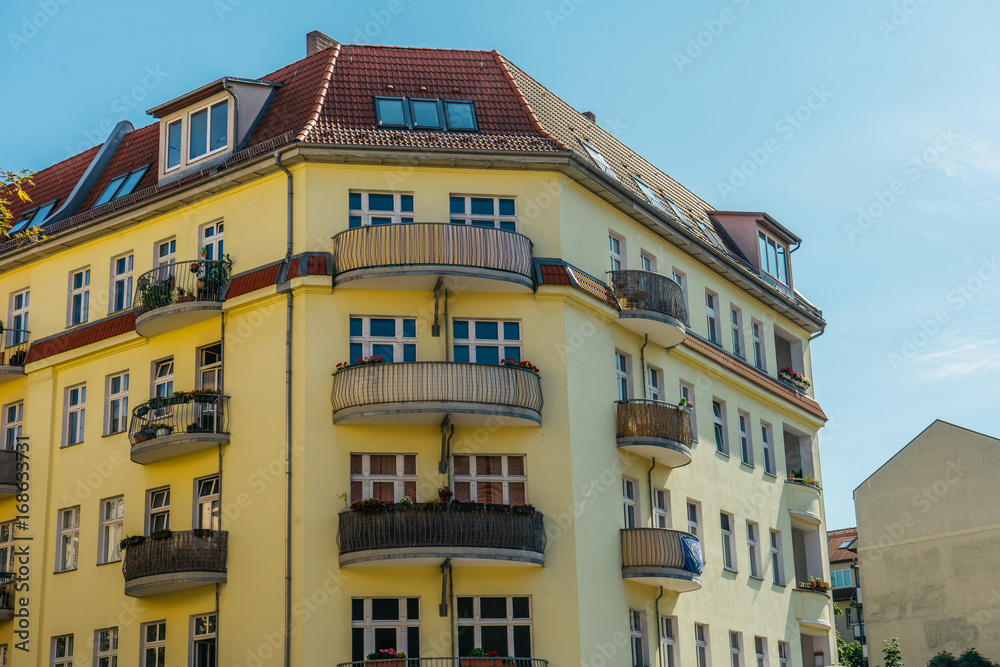 corner house with curved balconies on clean background