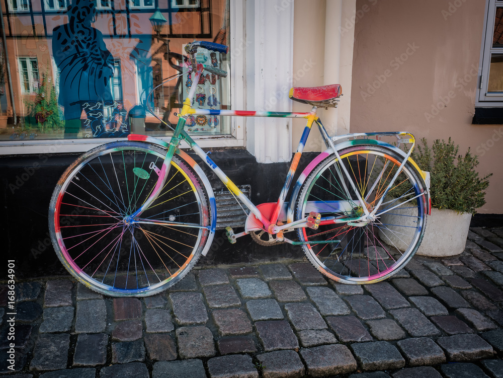 Multi colored bike on a paved road