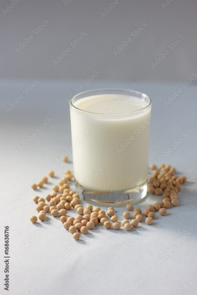 Soybean milk with soy beans around it Soybean milk with soy beans around it