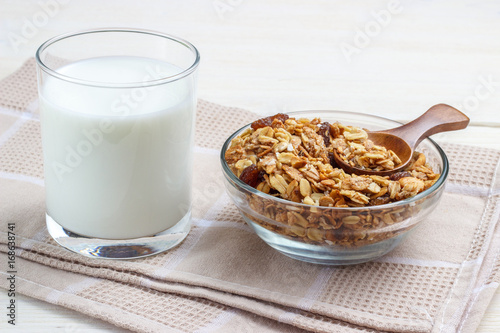 Breakfast glass of milk and muesli with glass bowl