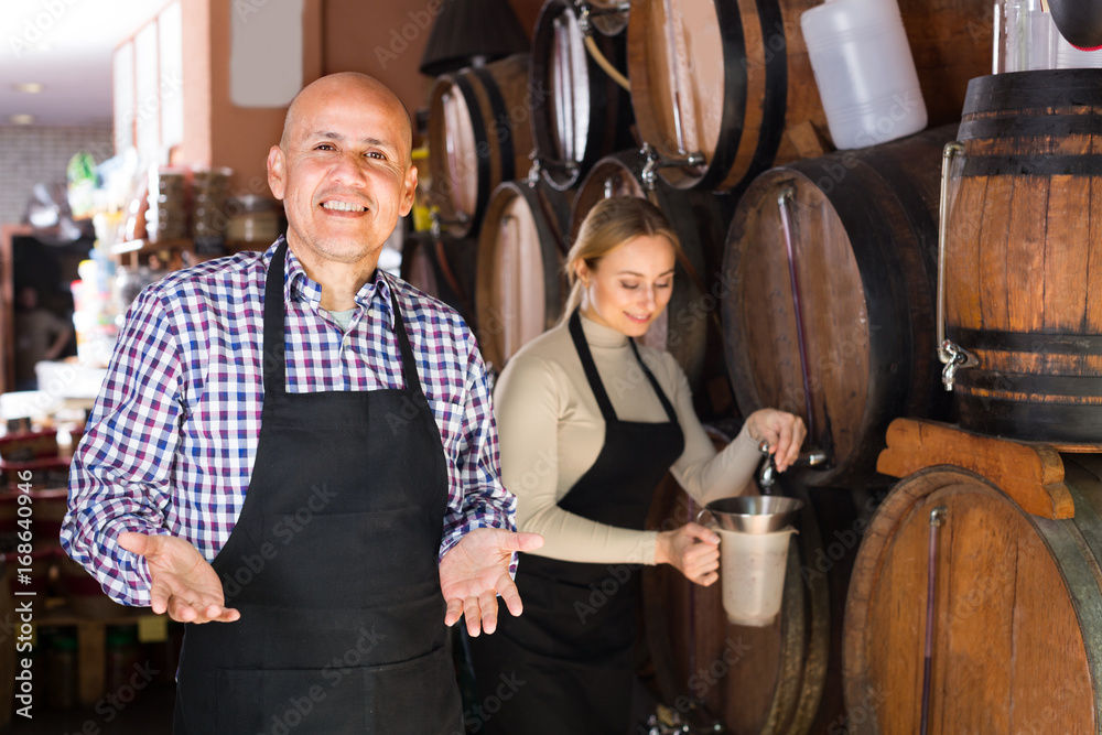 man and woman holding wine vessels