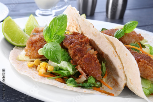 Delicious fish tacos on white plate, close up