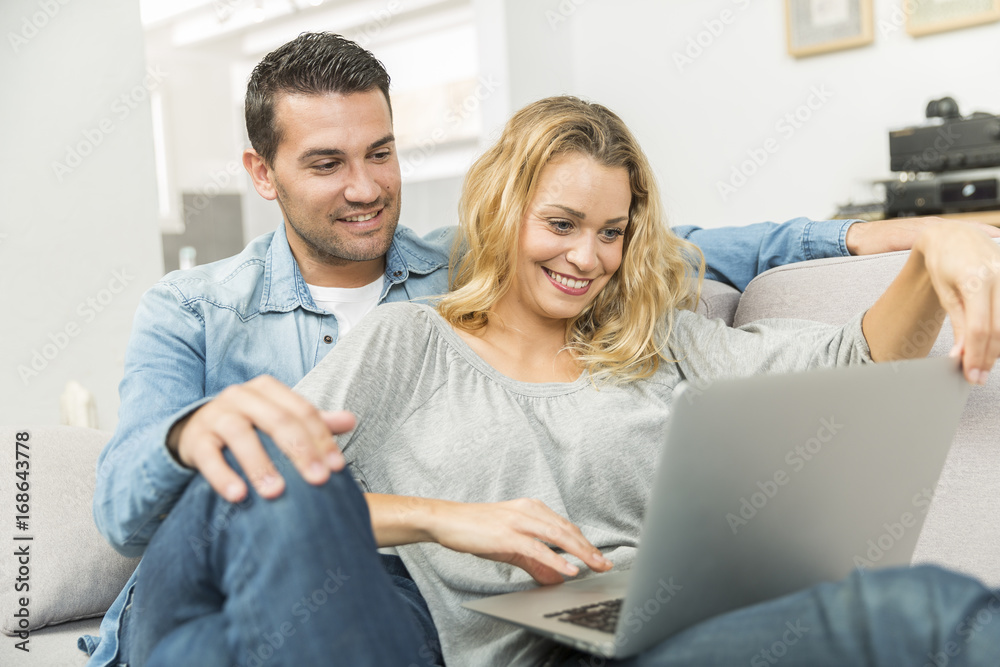 Young couple making the most of new technologies in their house Young couple making the most of new technologies in their house