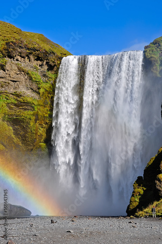 Skogafoss waterfall and rainbow. Skogafoss is a waterfall situated on the Skoga River in the south of Iceland at the cliffs of the former coastline.