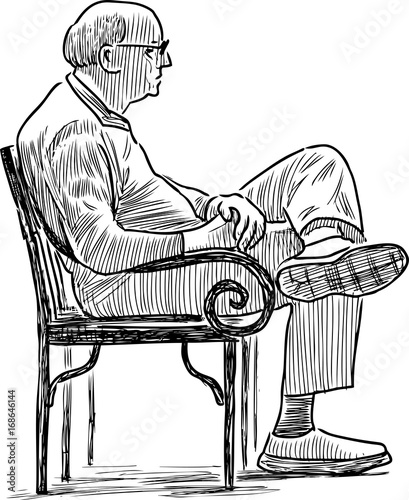 Elderly city dweller sits on the park bench