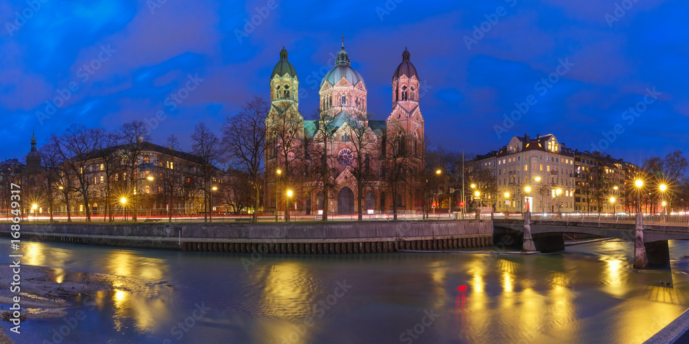 Panorama of Saint Lucas Church, the largest Protestant church in Munich, and Isar River at night, Bavaria, Germany