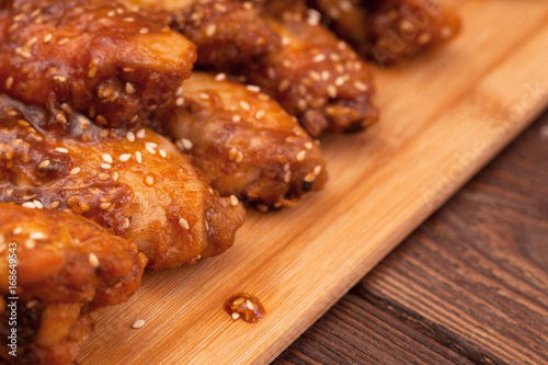 Chicken wings on a wooden table.