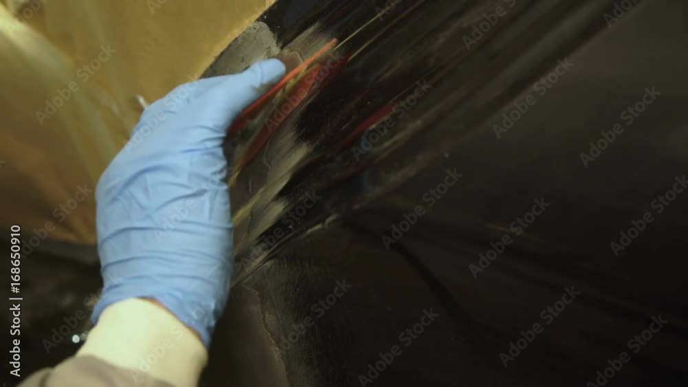 Applying the auto primer on the car body 4K Applying the auto primer on the car body 4K
