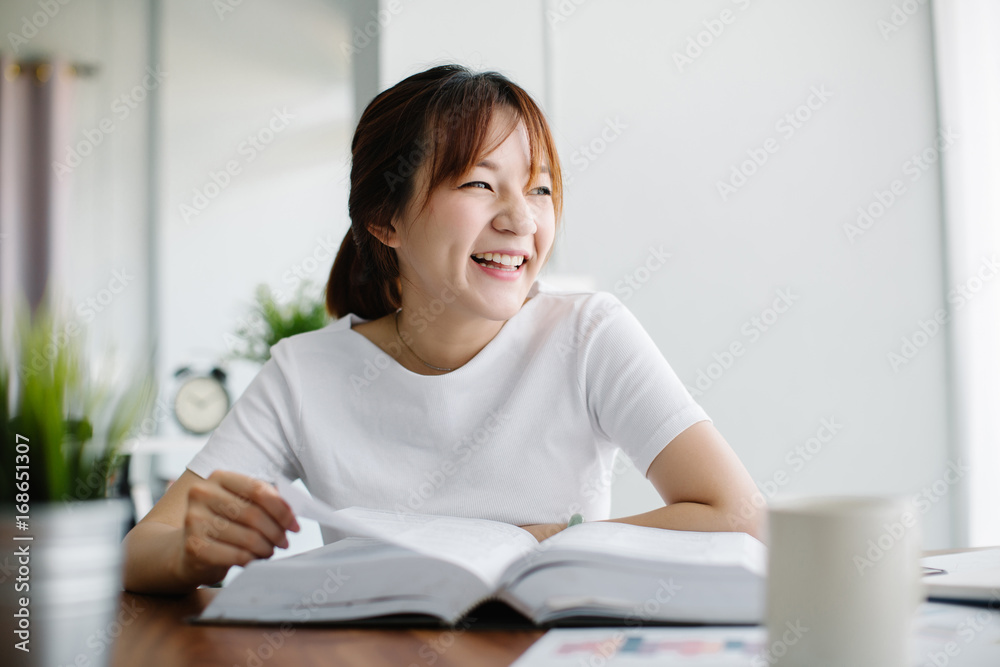 Young Asia woman reading a book at home Young Asia woman reading a book at home