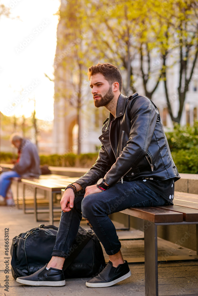 Young man sitting on a bench Young man sitting on a bench