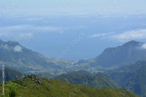 Panoramic view of maritime population from volcanic mountain above the clouds on the island of madeira © showbroadcaster