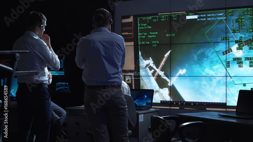 Obraz na plátne A group of people are controlling the orbiting international space station ISS