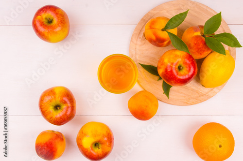 Ice tea with fresh fruit on a wooden background