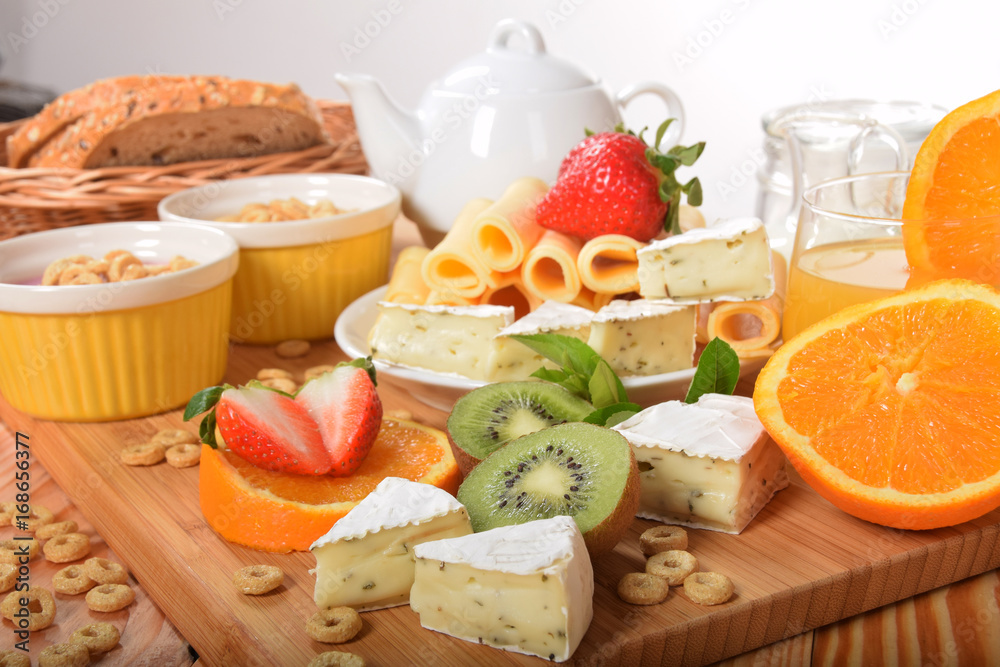 Strawberry orange and kiwi fruit on a dietetic breakfast With yellow Swiss cheese andWhite french with mold and pepper Strawberry orange and kiwi fruit on a dietetic breakfast With yellow Swiss cheese andWhite french with mold and pepper