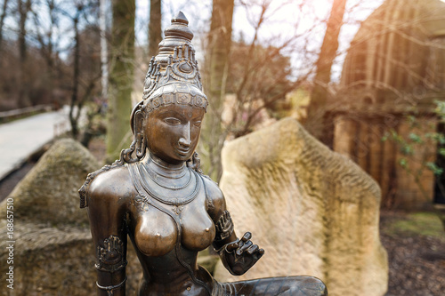 Goddess Parvati hinduism shiva wife bronze sculpture in park photo