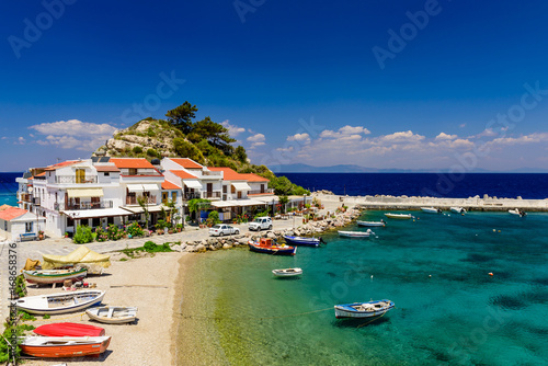 The picturesque village of Kokkari with traditional houses and fishing boats, Samos island, Greece. Kokkari village is a popular tourist place on the island of Samos.