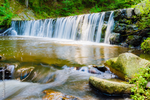 Beautiful small waterfall on nice creek in forest