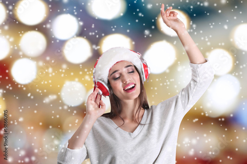 Young woman in Santa's hat ...