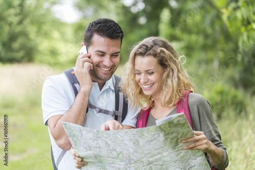 Hikers on the phone searching the way on a map