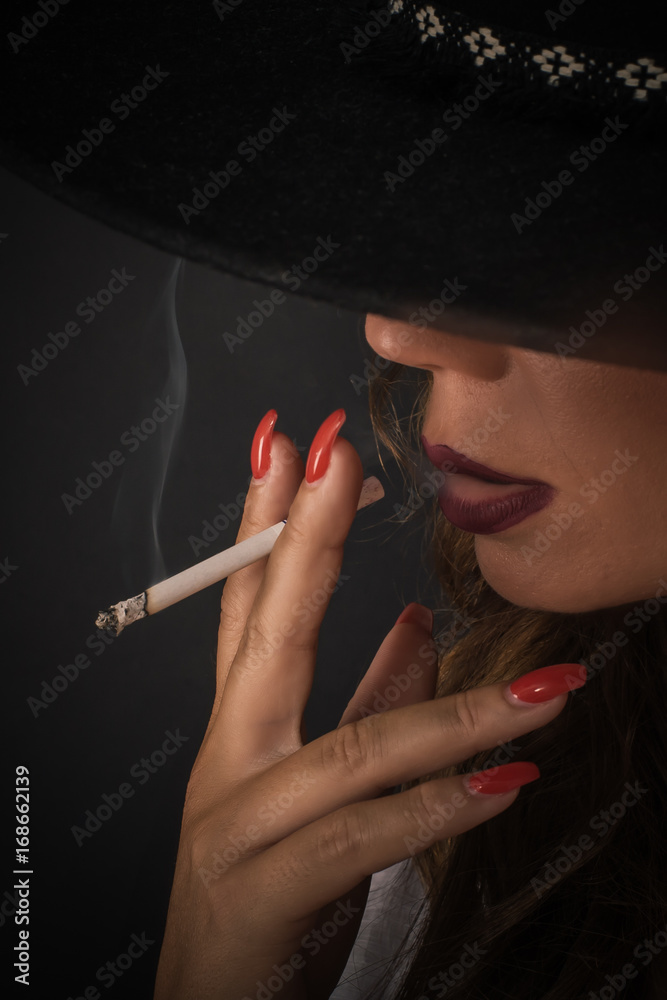 Portrait of sexy elegant lady woman with hat smoking cigarette Stock Photo  | Adobe Stock