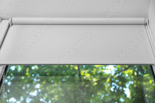 White roller blind on a metal plastic window