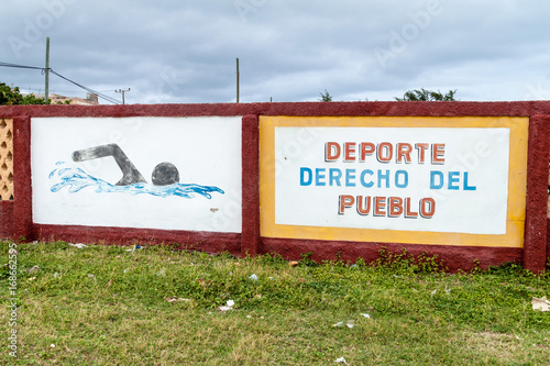 GIBARA,  CUBA - JAN 29, 2016: Mural on a wall of the swimming pool in Gibara village. It says: Sport, the right of the peoples. photo