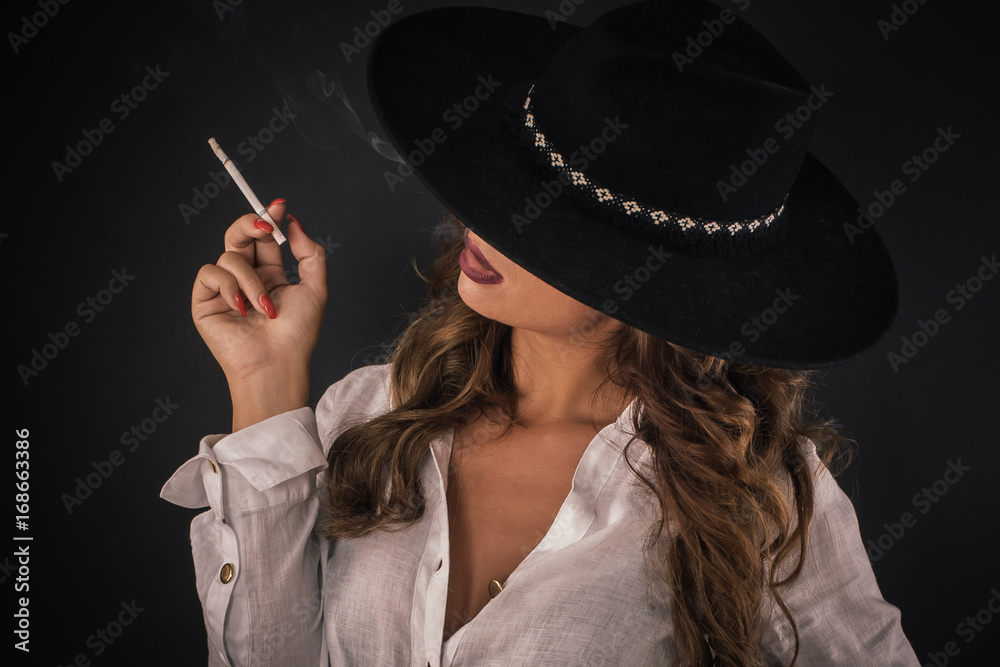 Portrait of sexy elegant lady woman with hat smoking cigarette Stock Photo  | Adobe Stock