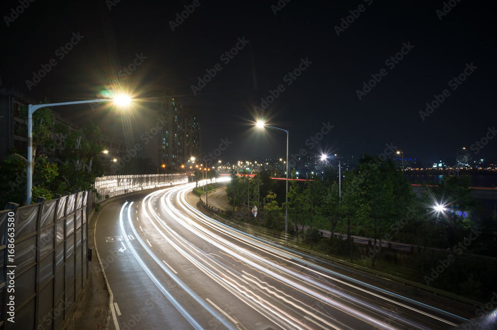 Speed Traffic at Dramatic Sundown Time - light trails on motorway highway at night, long exposure. Seoul South Korea