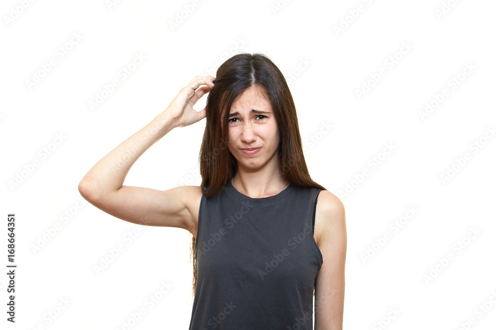 Girl emotions. White background. Portrait of young angry shocked woman holding head Girl emotions. White background. Portrait of young angry shocked woman holding head
